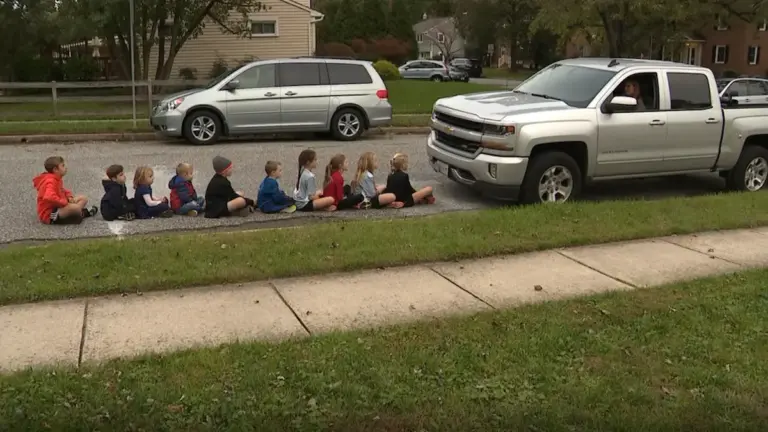 Image of children lined up in front of a large Chevy Truck demonstrating the large blind spot due to vehicle size.