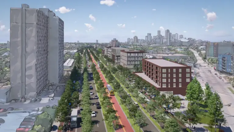 Rendering of boulevard where I-94 is, aerial drone shot looking west towards Minneapolis with the skyline in the background. Full of trees and green space, bus rapid transit lanes, and new development
