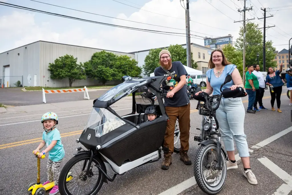 family smiling with cargo ebike