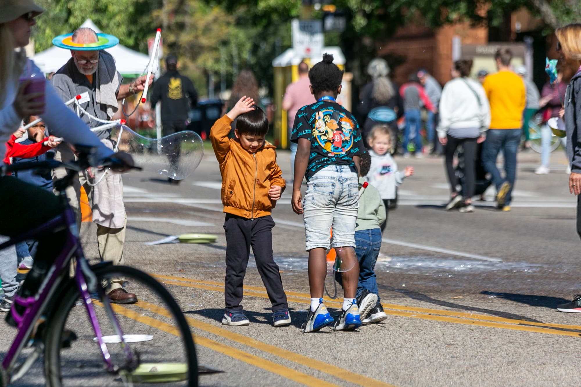 children playing together on street during festival