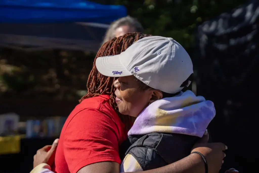 two Black women hugging