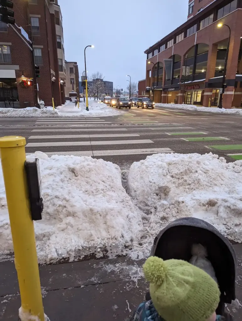 a mountain of snow piled up in an intersection, making it impassable