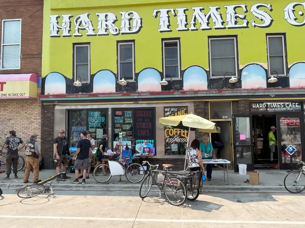A bunch of bikes and cyclists outside of Hard Times Cafe in Minneapolis.
