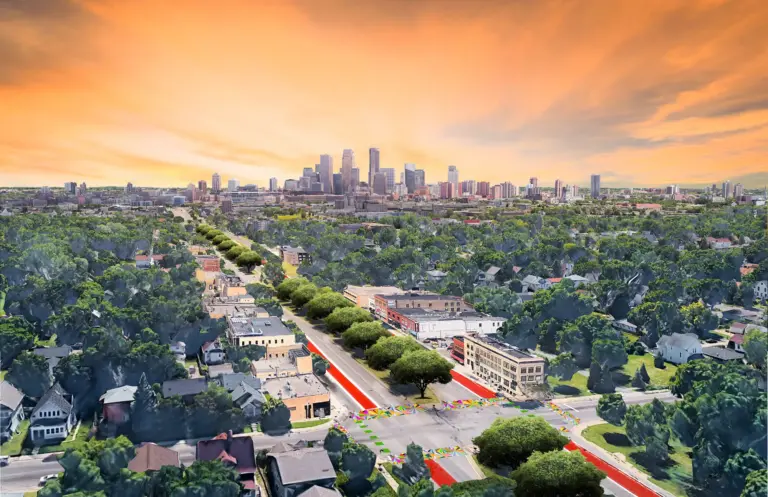 Aerial rendering of a restored 6th Avenue North, showing trees and greenspace, land available for community land trust development, bus only lanes, bike lanes, wide sidewalks, and more.