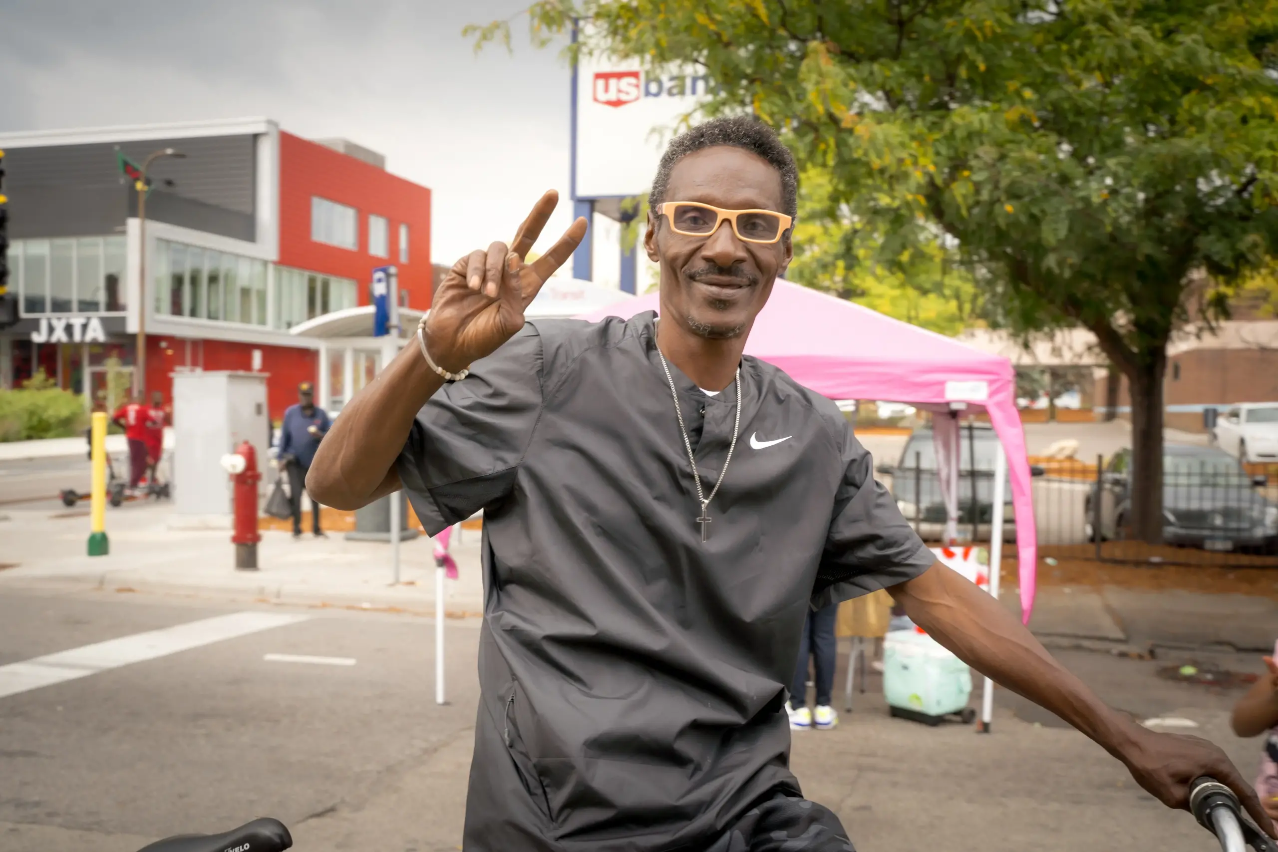 guy wearing fun glassing throwing a peace sign