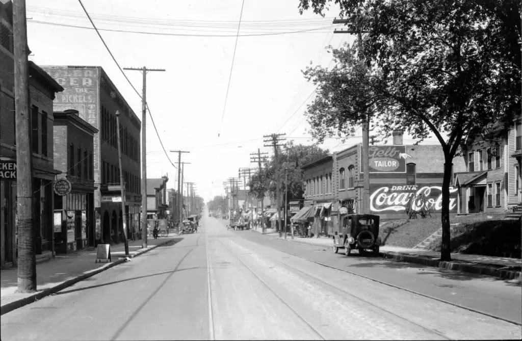 Intersection of 6th and Lyndale Ave in Minneapolis before the highway, showing buildings and streetcar line