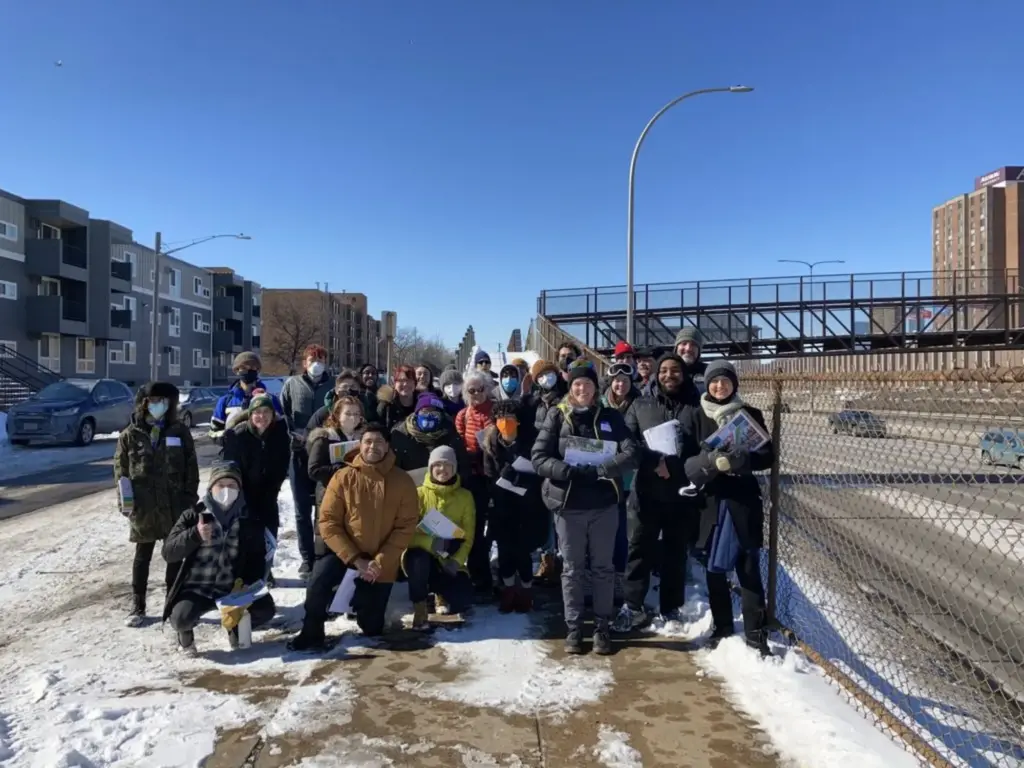 Volunteers pose near I-94 at the Twin Cities Boulevard canvass launch