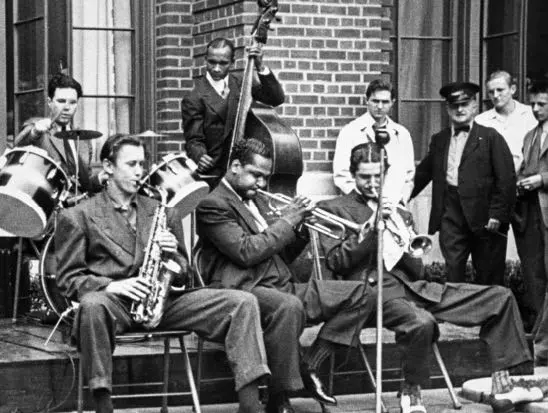 group of jazz musicians playing, an old black and white photo from the 30s