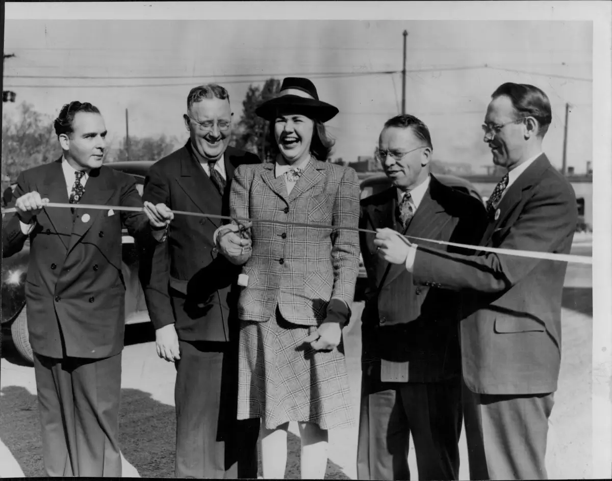 Patricia Olson, daughter of the late Governor Floyd B. Olson, snips a ribbon at the new Olson Memorial highway opening ceremony.
October 16, 1940