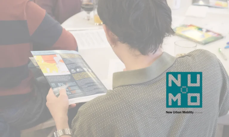 numo logo over photo of someone looking at brochure at an event