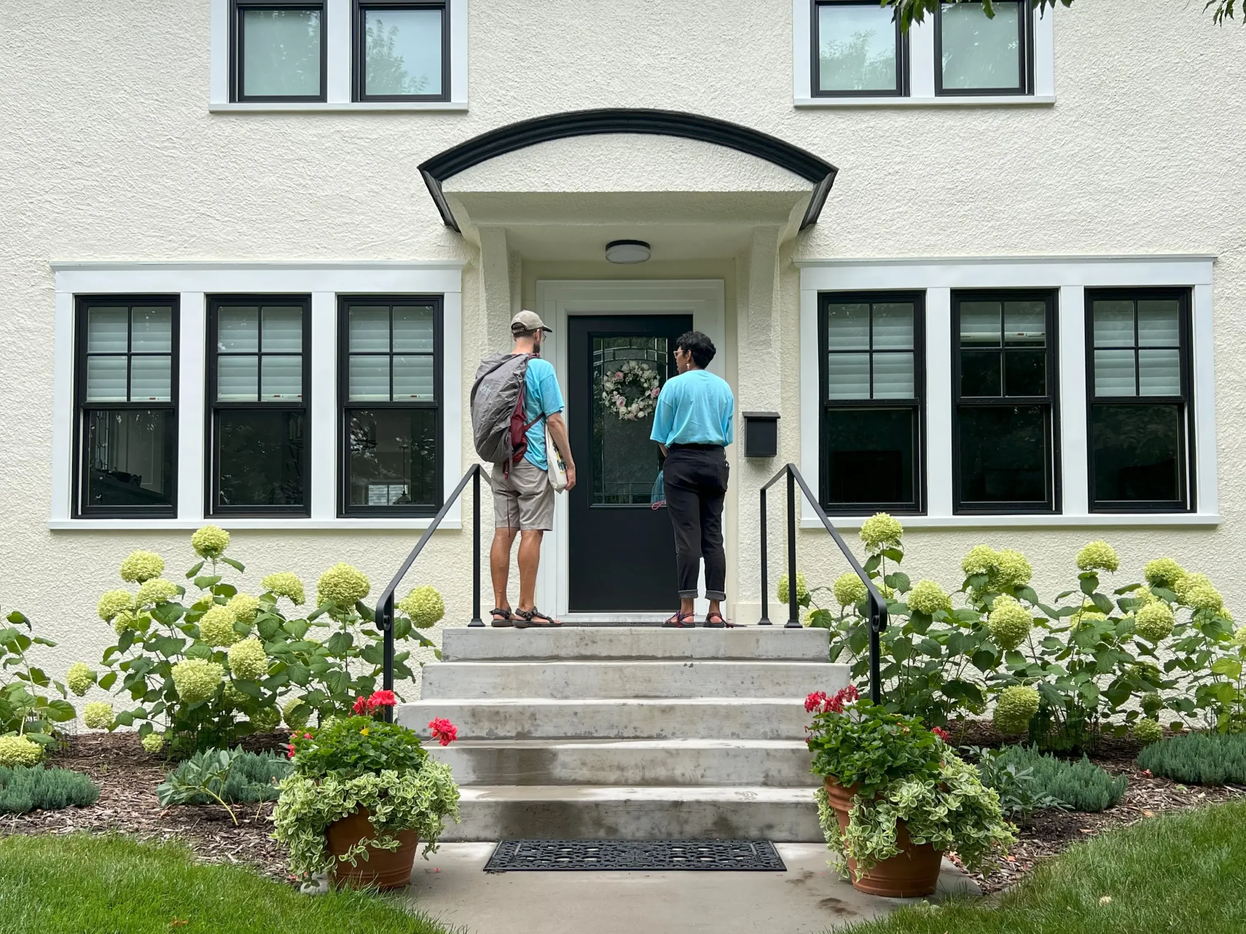 two people standing at a door with canvassing materials