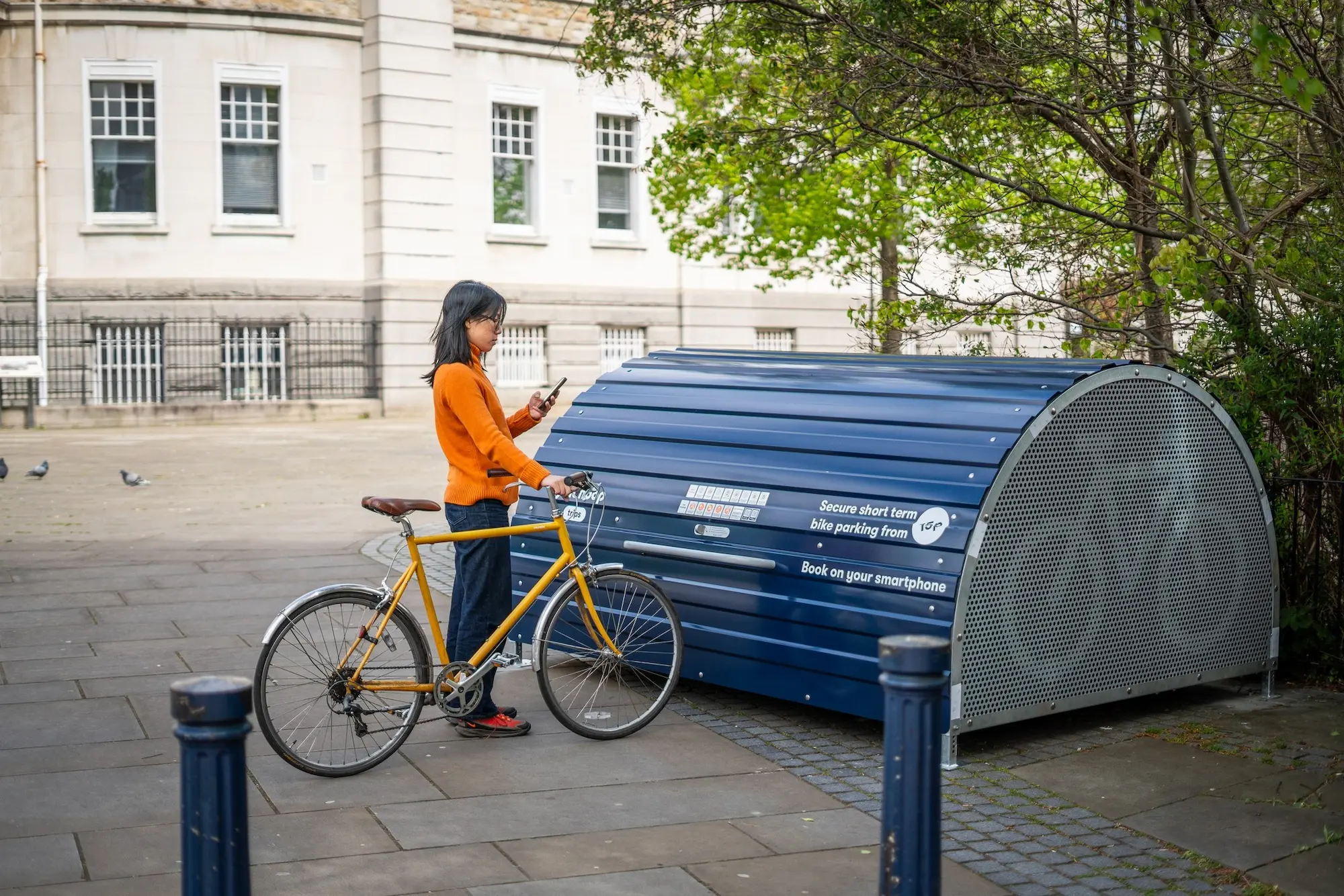 person with bike outside a secure biking spot