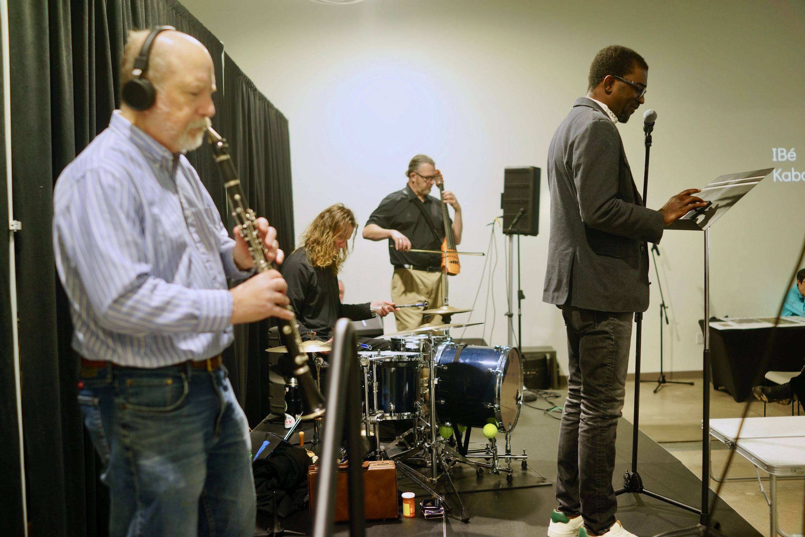 94 Stories Time Machine speaker sharing their story with the band Sonoglyph Collective.