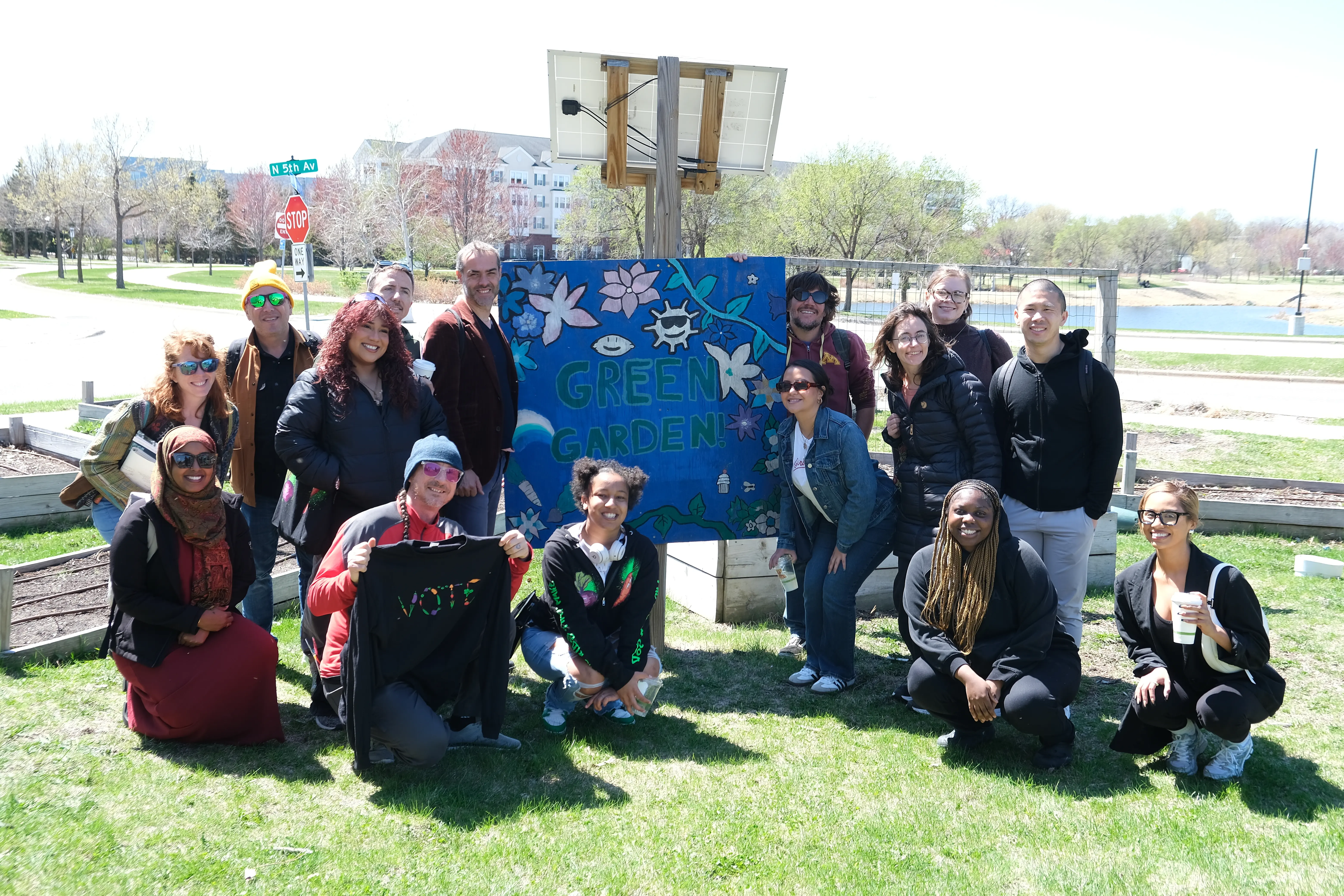 Group photo of Green Garden Bakery youth giving showing their gardens to the Communities Over Highways conference attendees.