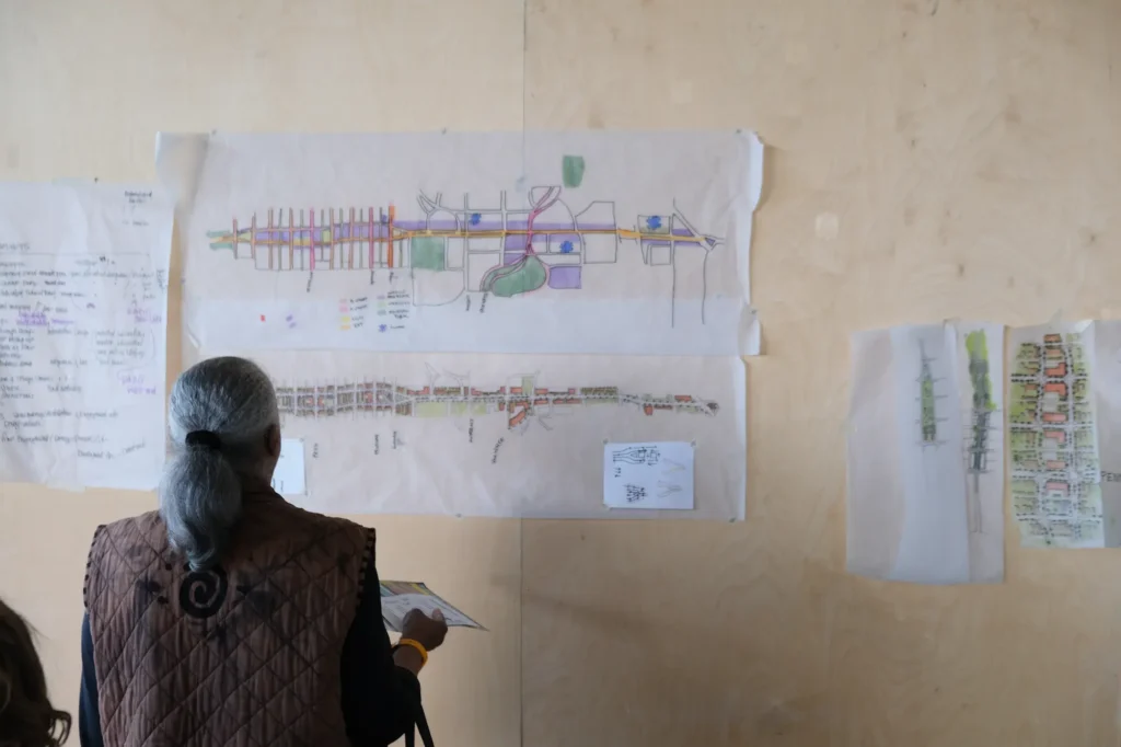 woman looking at hand-drawn rendering of what could be on Olson Memorial Highway.